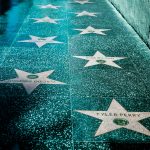 Capture of the Hollywood Walk of Fame stars on a shiny sidewalk in Los Angeles.